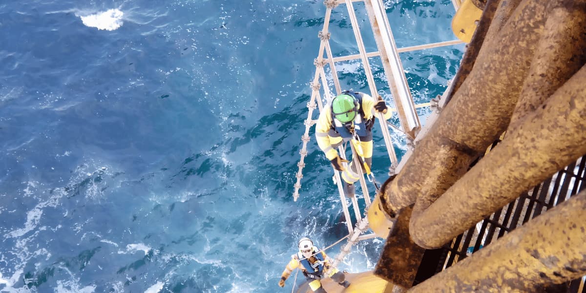 Technician performing ultra-high-pressure water blasting on a marine surface