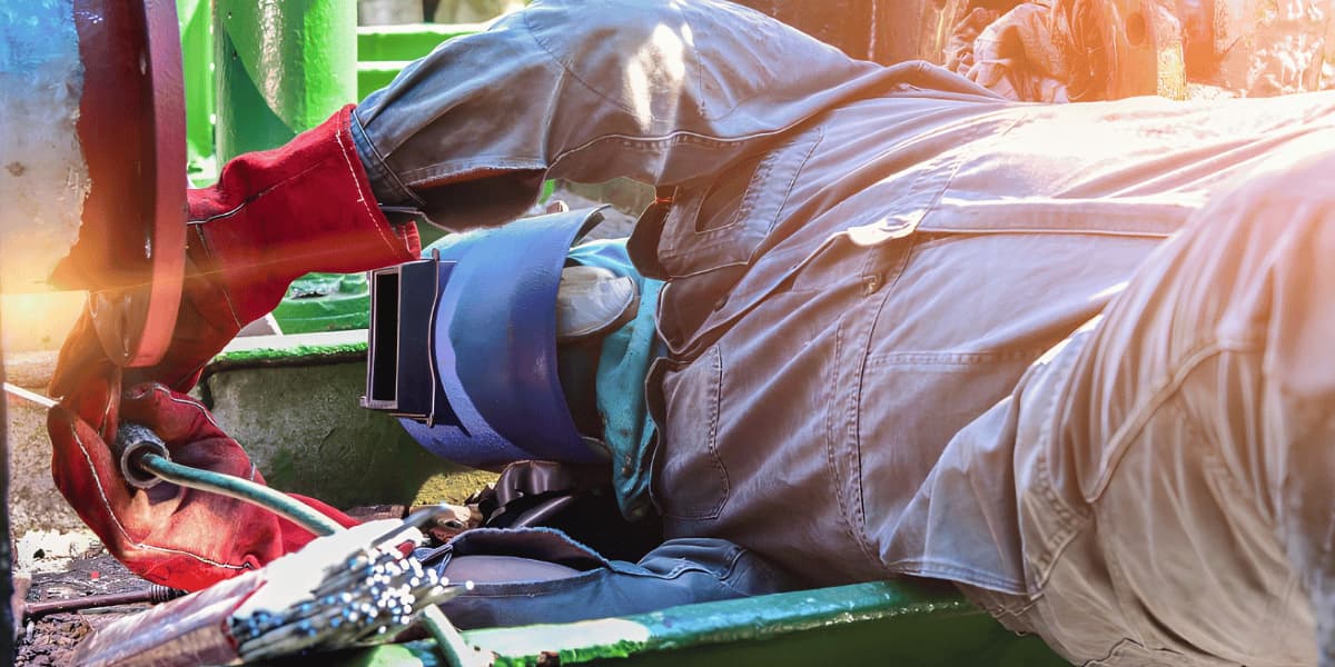 Trussco technician performing industrial welding and repair work