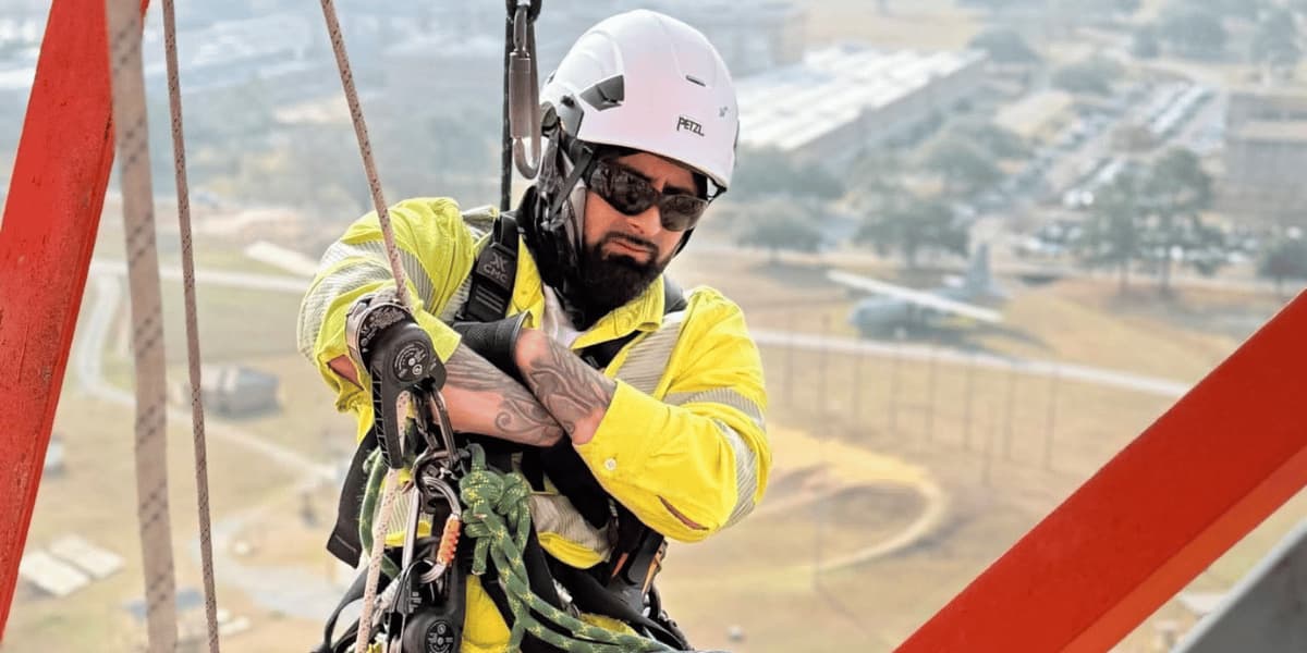 Trussco rope access technician working safely at height in an industrial environment