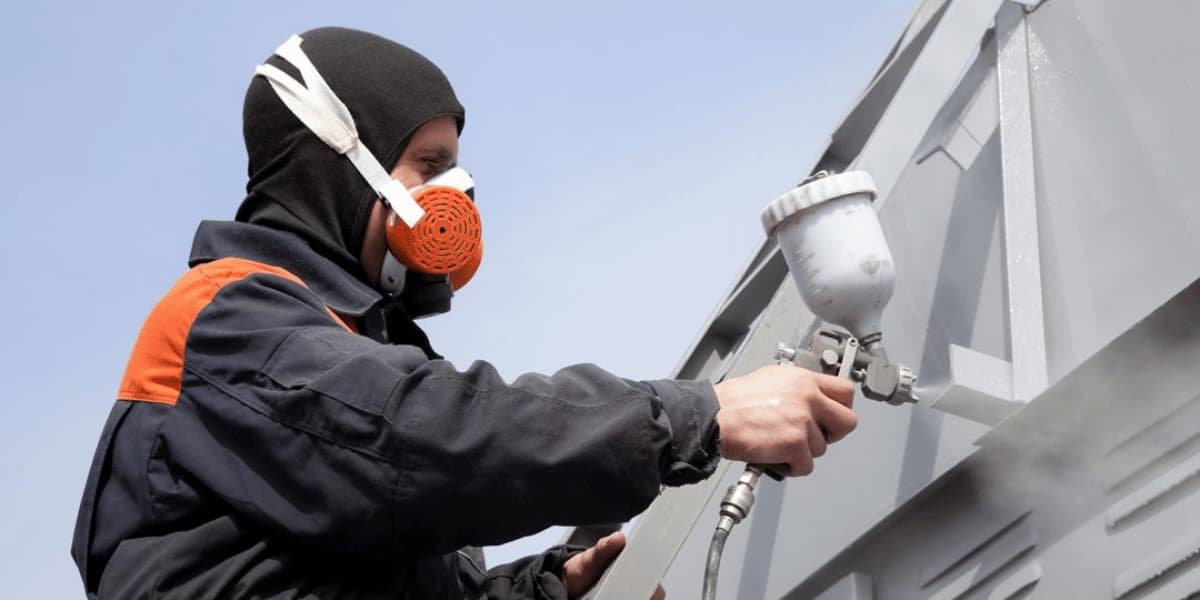 Trussco Protective Coating Services Technician applying protective coating to an industrial metal surface
