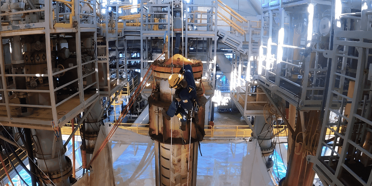 Trussco rope access technician performing maintenance on offshore oil and gas equipment